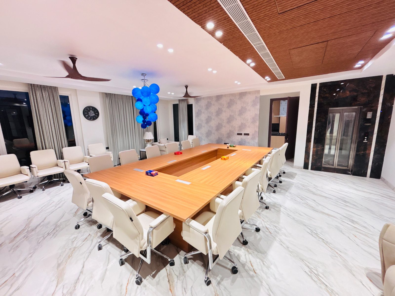 Villa meeting room with wooden conference table and blue pendant light